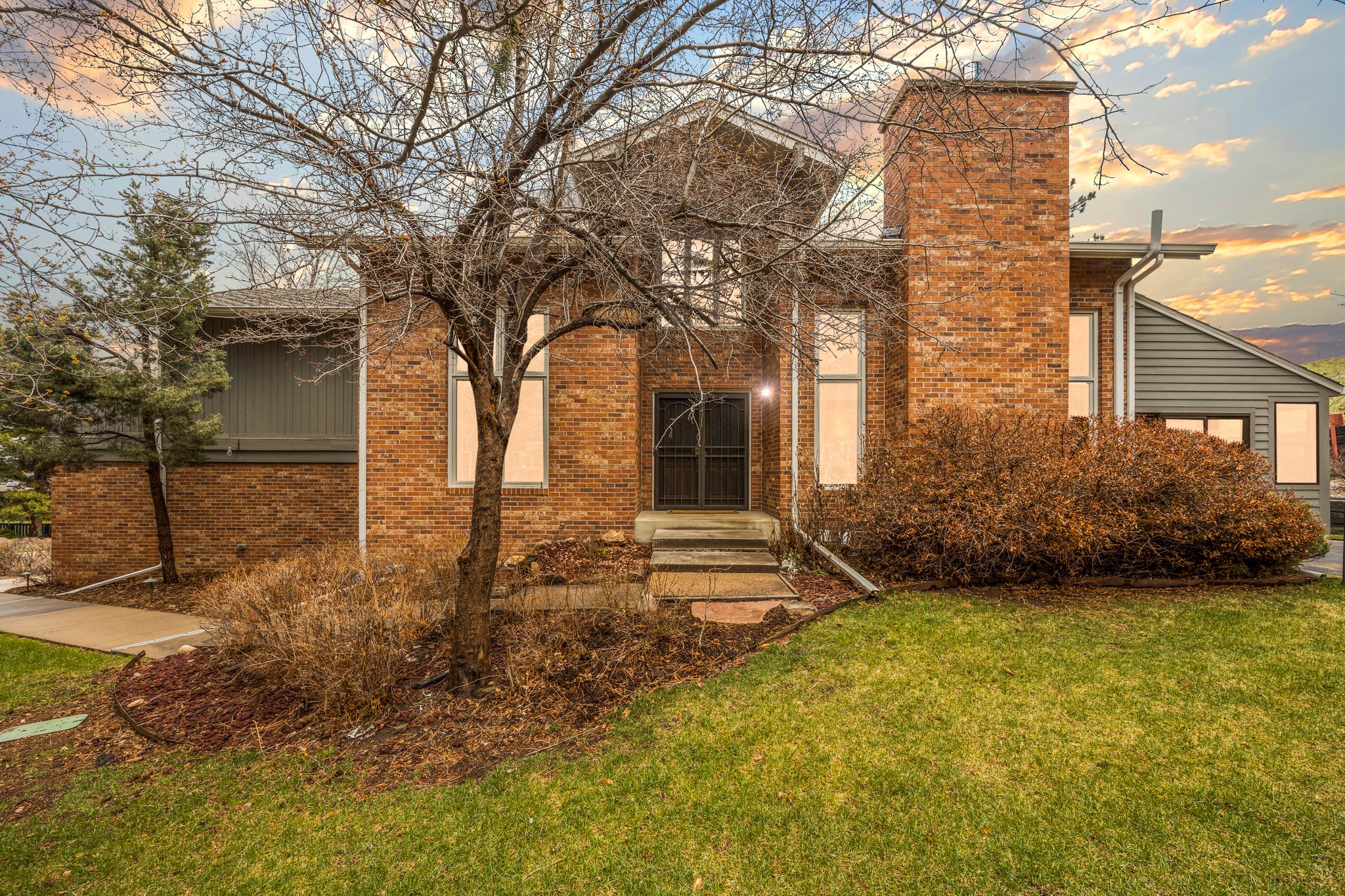 Brick exterior townhome at sunset at 14556 W 3rd Ave in Golden Colorado