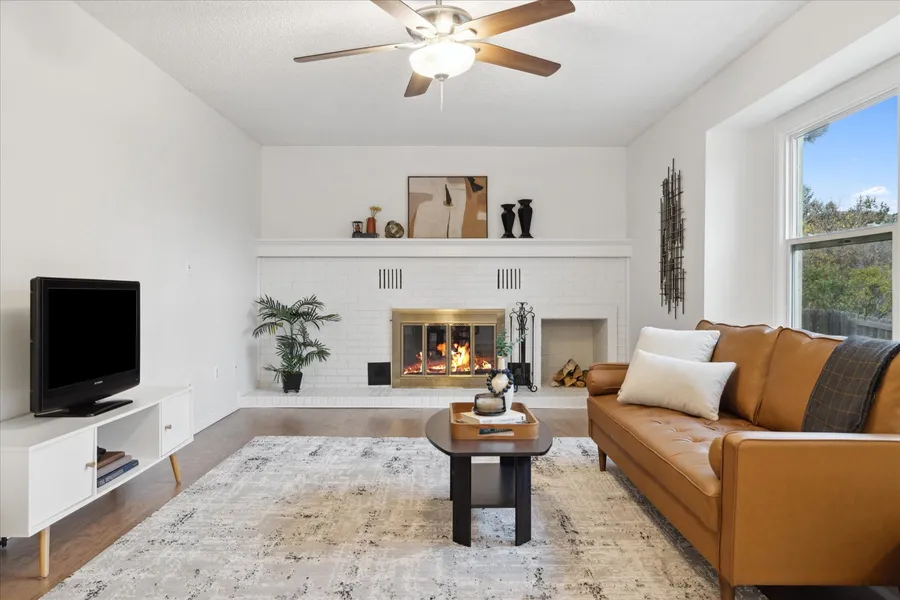 Family room after fresh paint, including the brick fireplace, and staging