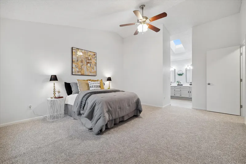 The same primary bedroom after paint, new carpet, and staging